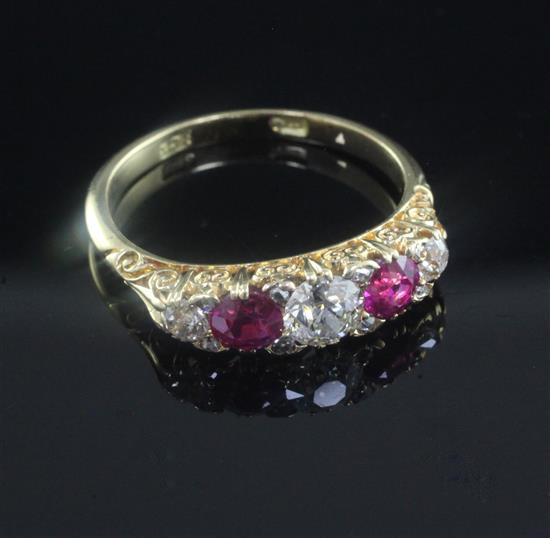 A 20th century 18ct gold and graduated five stone ruby and diamond half hoop ring, size Q.